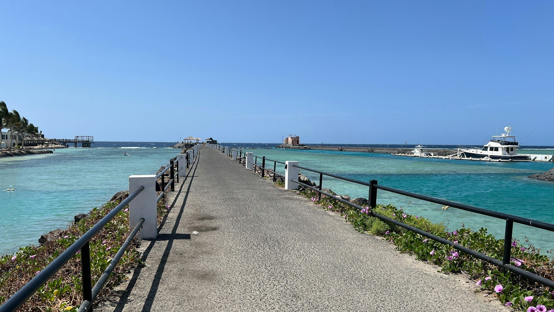 Blue-green sea alongside a waterfront walkway in Jeddah